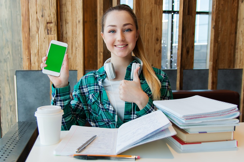 with phone and books